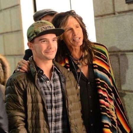 A smiling picture of Taj Monroe Tallarico with his father Steven Tyler 